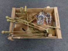 A box containing late 19th century brass companion pieces, fire dogs, copper tray, plated wares etc.