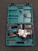 A cased Makita 18 volt jigsaw with battery and charger.