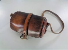 A vintage leather lawn bowls bag with carry strap.