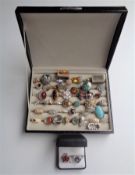 A ring box containing a large quantity of assorted dress rings.