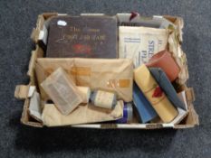 A box containing a vintage first aid kit and dressings.