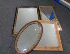 An Edwardian beech framed oval bevel edged mirror together with three further framed mirrors.