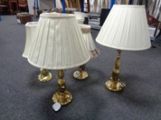 A pair of brass table lamps with shades together with two further lamps with shades