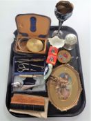 A tray containing miscellaneous items to include compacts, manicure sets, plated wares,