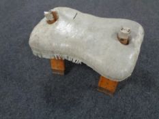 A camel stool with leather saddle