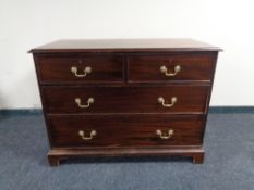A Georgian style mahogany four drawer chest with brass drop handles