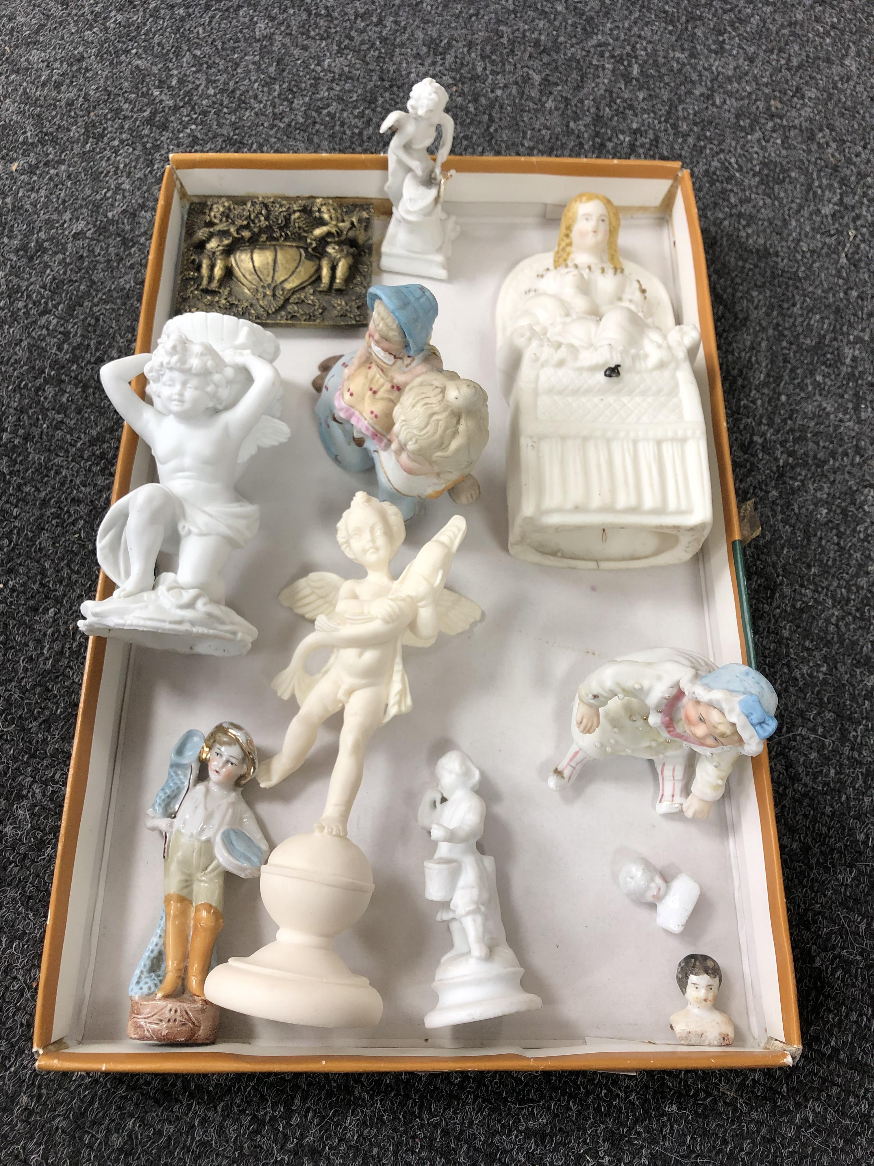 A box containing antique and later china and Parian figures, china dolly tops.