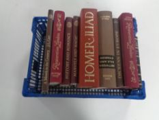 A basket containing nine Folio Society volumes to include Restoration London, Homer's Iliad etc.