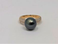 A 14ct gold diamond and Tahitian pearl ring, the total diamond weight 0.61 carat, size L.