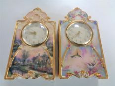 Two Bradford Exchange Heirloom porcelain clocks by Thomas Kinkade and Larry Martin.