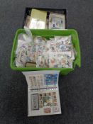 Two boxes containing a large quantity of loose world stamps, first day covers.