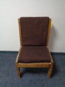 A mid century teak framed high backed chair with brown cushions