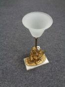 A nineteenth century gilt metal table lamp in the form of a cherub on marble base
