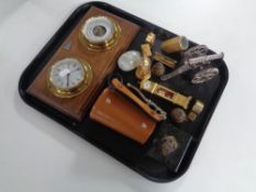 A tray containing ship's style barometer and clock mounted on a board,