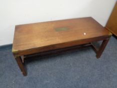 A ship's style coffee table with under stretcher and brass mounts