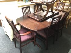 A late 20th century Danish Mobler extending dining table with two leaves and a set of six rail back
