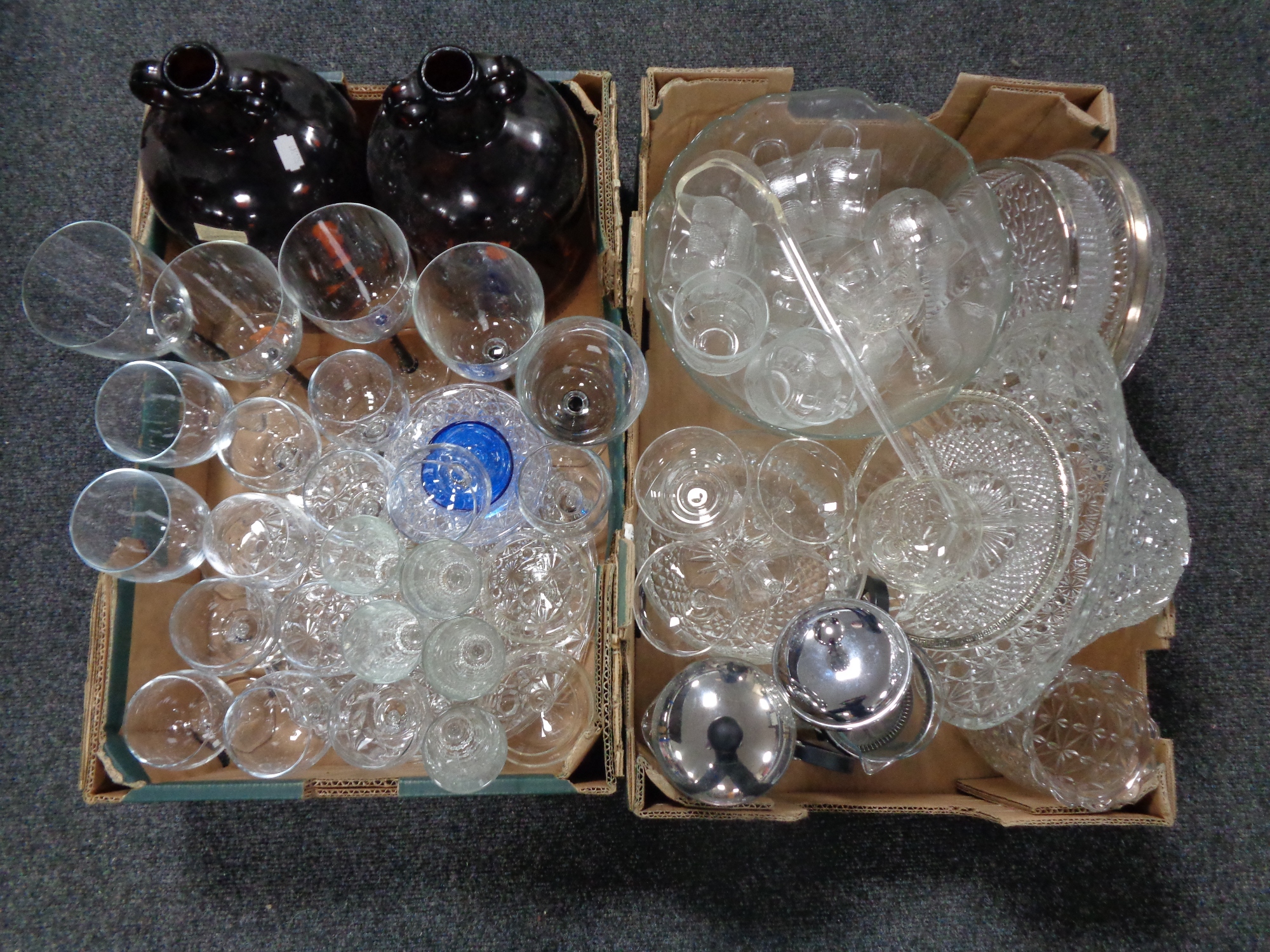 Two boxes containing assorted glassware to include demijohns, drinking glasses, punch bowl,