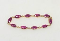 A 14ct yellow gold ruby and diamond bracelet, set with ten marquise-cut rubies (14.