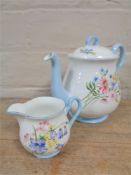 A Shelley Wild Flowers milk jug together with similar teapots (unstamped).