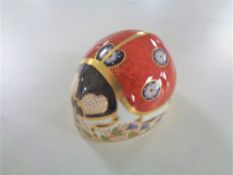A Royal Crown Derby ladybird paperweight with silver stopper.