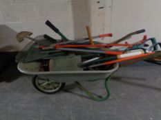 A wheel barrow containing a large quantity of garden tools