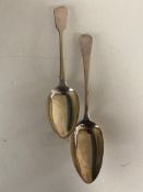 Two silver table spoons, 147g, London 1902 and 1827.