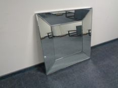 A contemporary all glass framed bevel edged wall mirror.