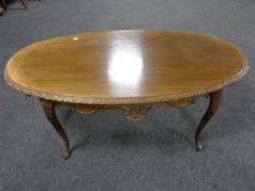 An oval continental coffee table on cabriole legs