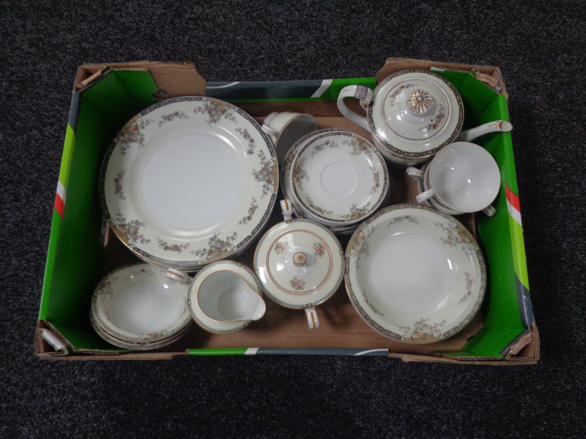 A box containing a Japanese tea and dinner service.