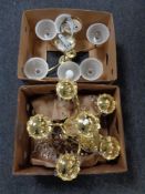 Two boxes containing a five way brass chandelier and light fitting with glass drops together with