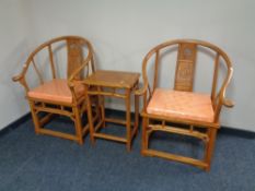 A pair of Chinese elm armchairs with matching occasional table