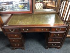 A twin pedestal writing desk fitted with nine drawers with green tooled leather inset panel (a/f)