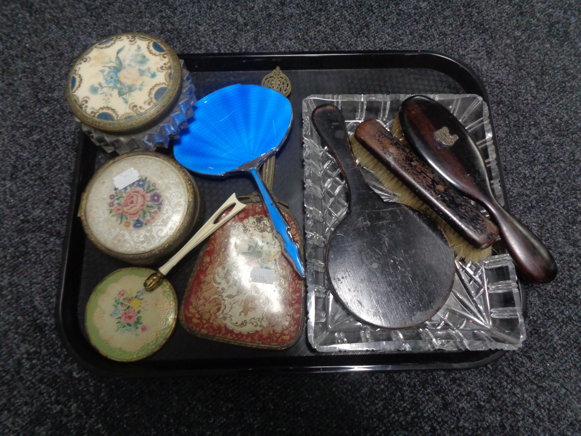 A tray containing cut glass trinket tray, dressing table brushes and mirrors, powder bowls.