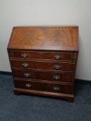An inlaid mahogany writing bureau fitted with four drawers