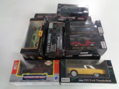 A tray containing nine assorted boxed die cast vehicles to include Maisto 1..