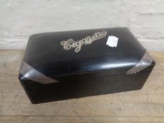 A 20th century ebonised cigarette box with silver mounts.