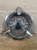 A decorative white metal ashtray with hammered sunflower design, 90.6g.