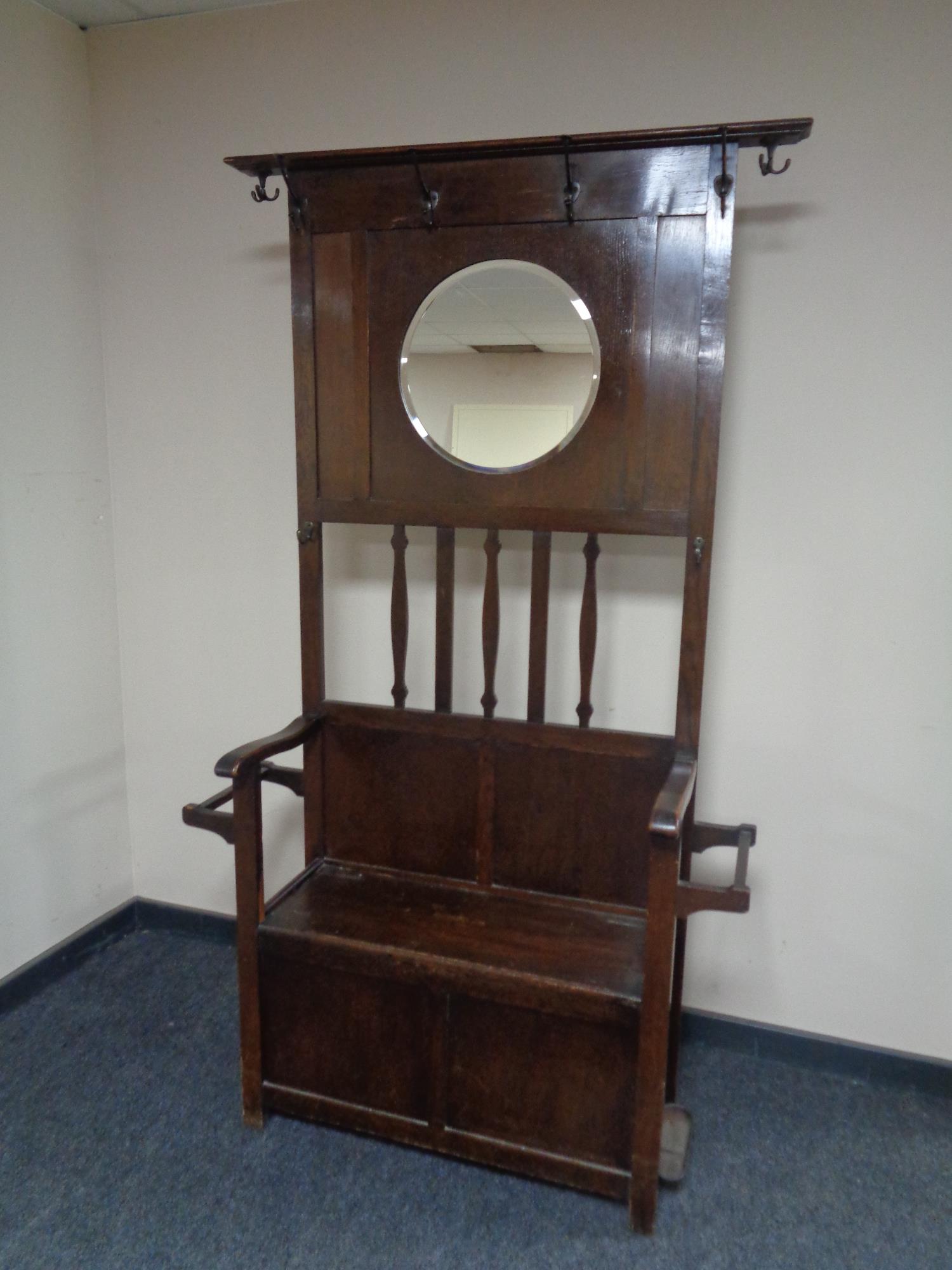 An Edwardian oak mirror hall stand