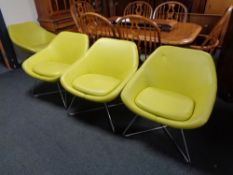 Four twentieth century lime green leather tub chairs on tubular metal legs