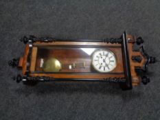 A twentieth century mahogany cased Vienna eight-day wall clock with brass and enamelled dial