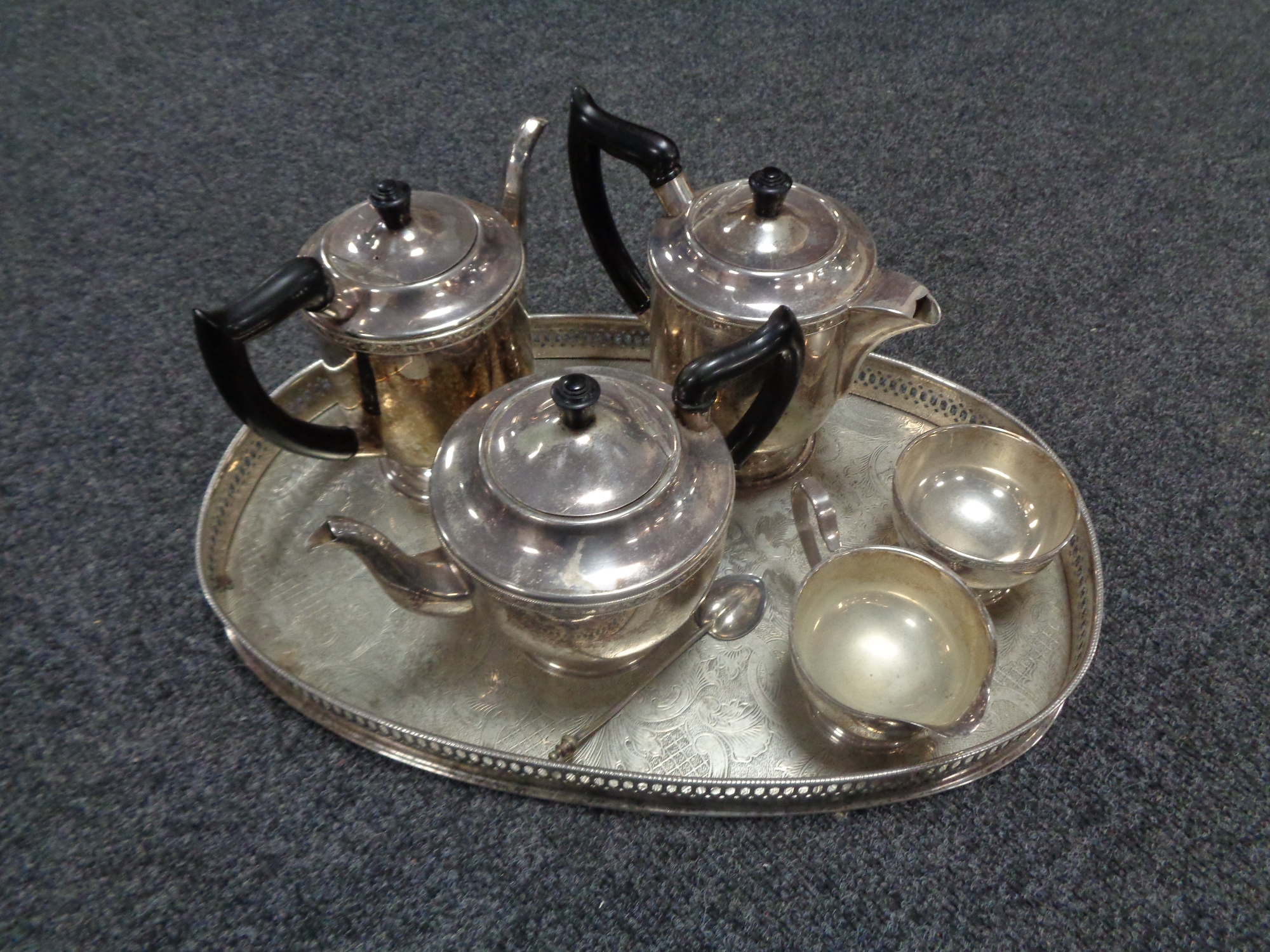 A silver plated serving tray containing five piece Viner's plated tea service