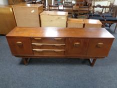 A mid century teak low cocktail sideboard