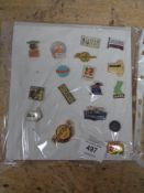 A quantity of continental enamelled pin badges on card
