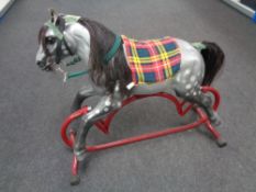 A mid 20th century tin plate rocking horse.