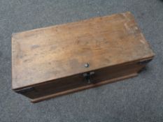 A small wooden storage box with metal mounts.