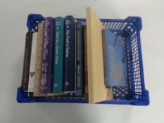 A basket containing ten Folio Society volumes to include Muriel Spark, Susan Cooper etc.