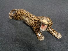 A glazed pottery figure of a leopard.