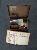 A vintage leather case containing strand stamp albums containing stamps of the world,
