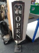 A retro style floor standing shop Open/Closed sign