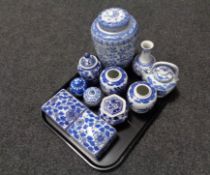 A tray containing blue and white oriental style lidded vases, ginger jars, trinket boxes,